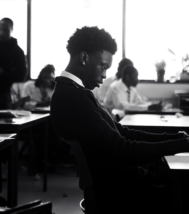A man sitting at a desk using a laptop computer